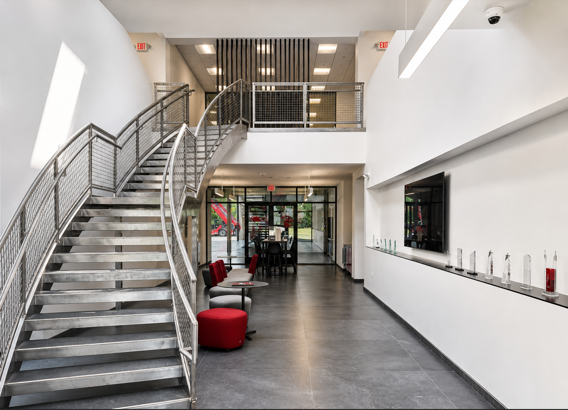Modern commercial fit-out interior with open staircase and atrium by Moore Construction