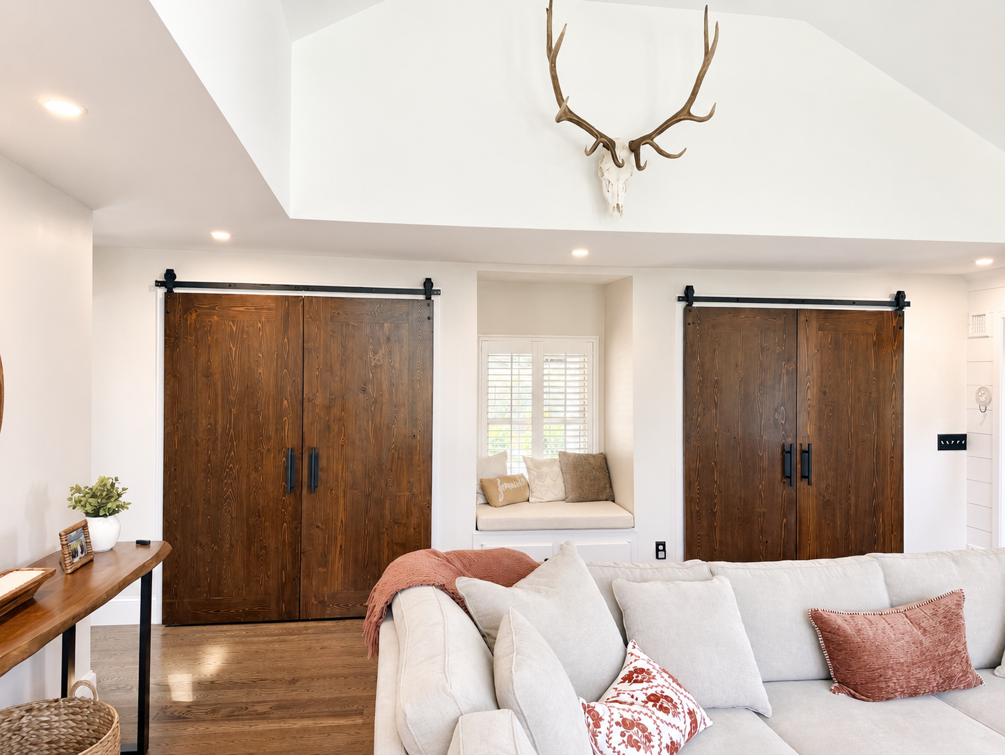 Custom bifold barn doors with vaulted ceiling in renovated living space