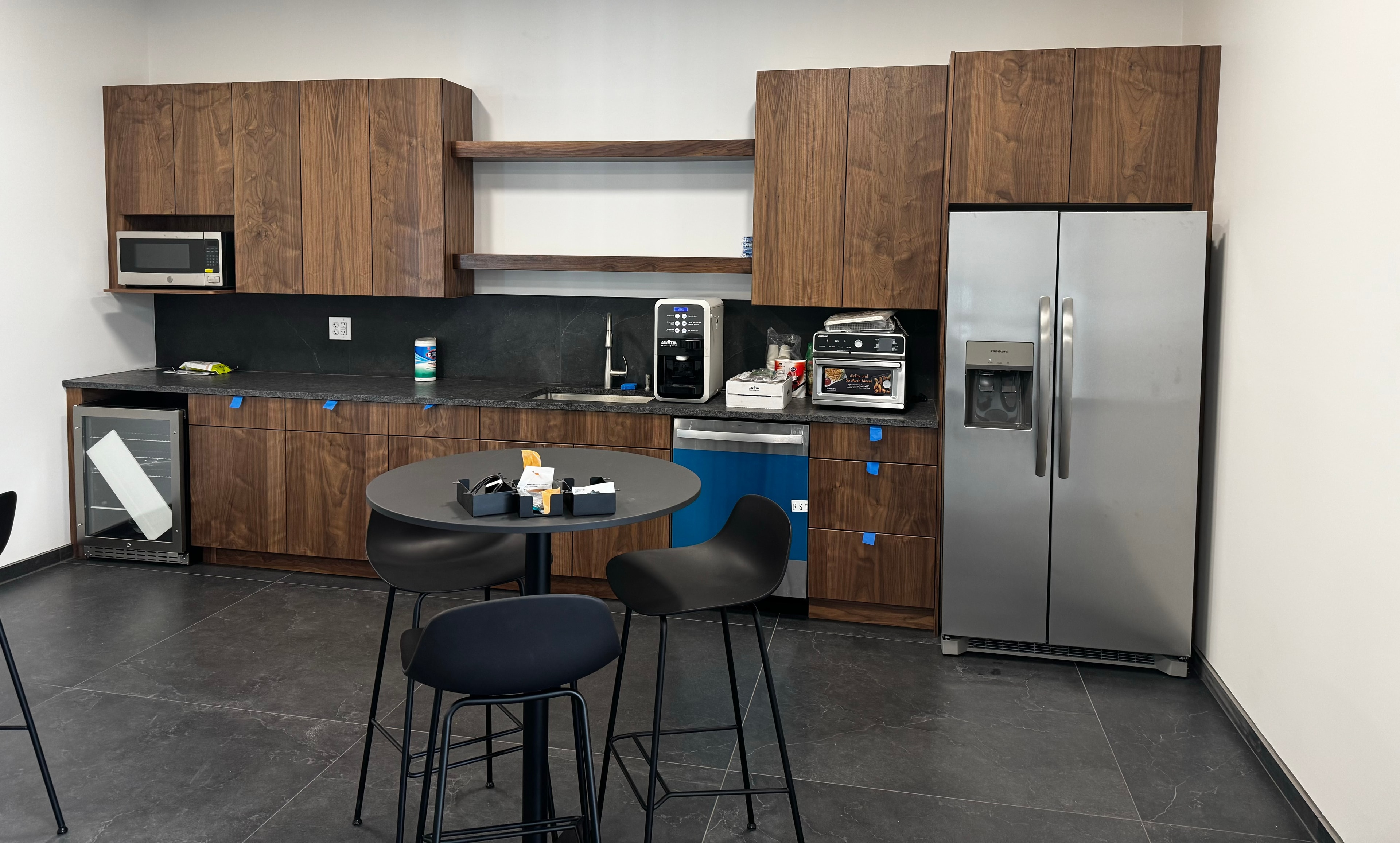 Magni America office kitchen with custom cabinetry and stainless appliances