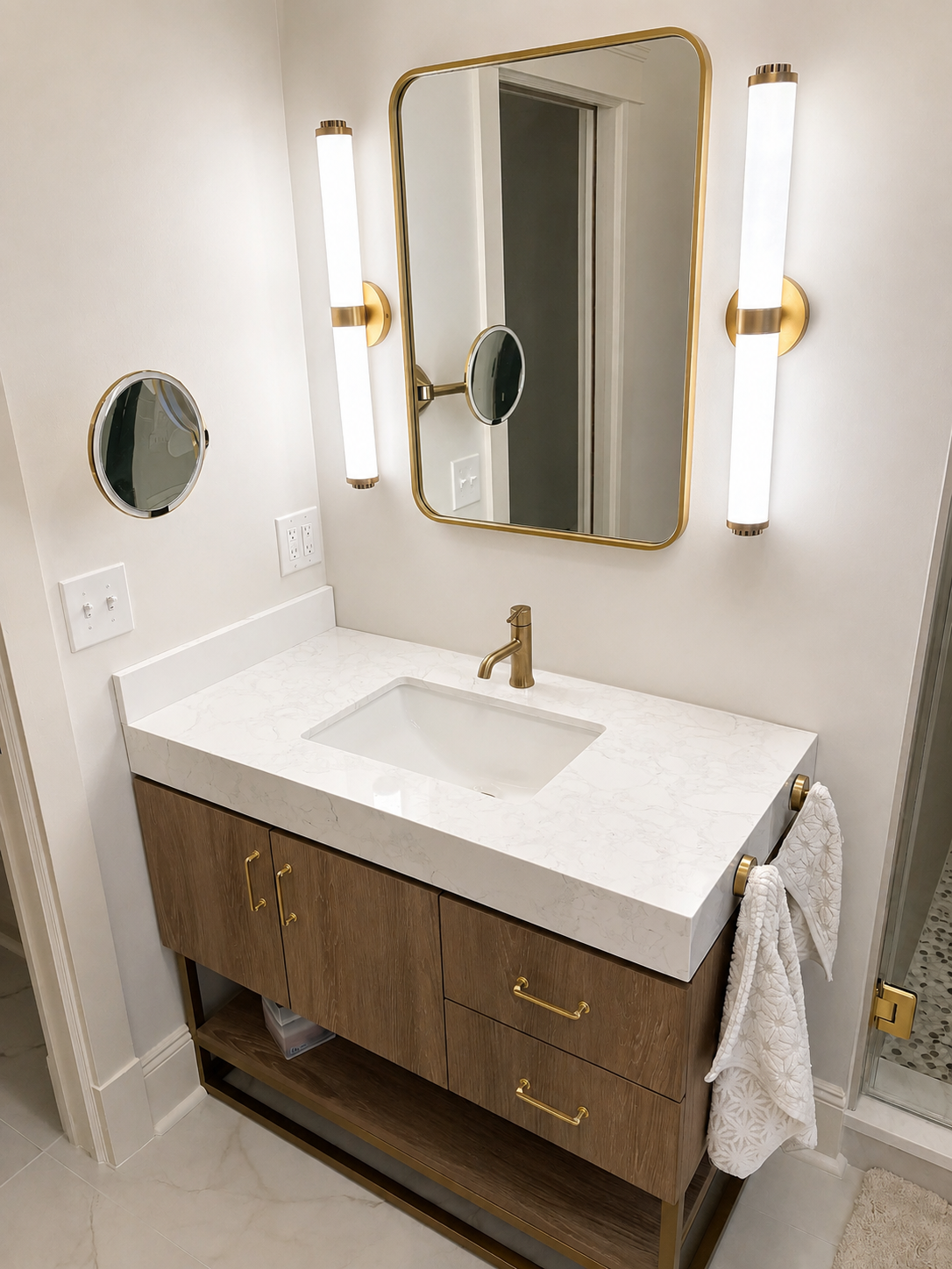 Makeover on Maye — custom wood vanity with quartz countertop and brass fixtures