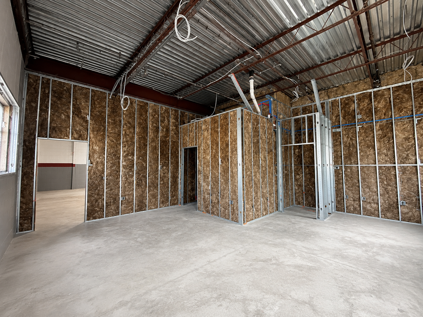 Newark Warehouse interior fit-out under construction with metal stud framing and insulation